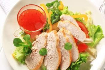 Sliced chicken breast fillet with salad and sweet chilli sauce