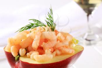 Half apple topped with shrimps