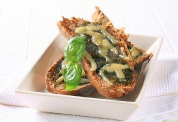 Toasted pesto bread topped with cheese