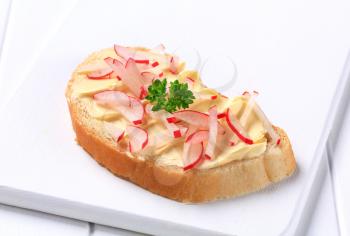 White bread with butter and chopped radishes