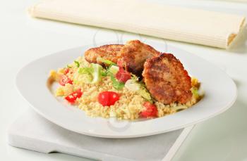 Dish of vegetable burgers with couscous
