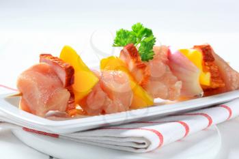 Raw chicken shish kebab with yellow pepper and bacon