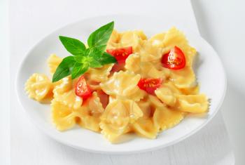 Bow tie pasta with cream sauce and tomato