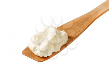 White cream on wooden spatula