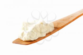 White cream on wooden spatula