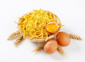 Thin spaetzle in a wooden bowl