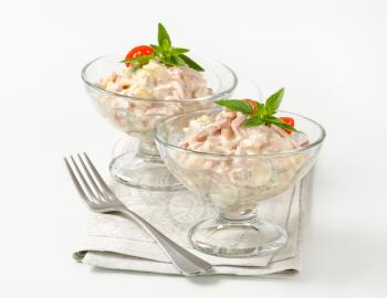 Ham and potato salad in glass serving bowls