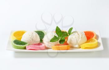 Scoops of white ice cream garnished with jelly candy