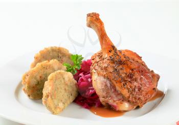Dish of roast duck leg with Tyrolean dumplings and red cabbage