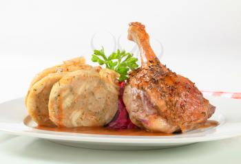 Dish of roast duck leg with bread dumplings and red cabbage