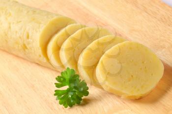 Cooked potato dumplings on cutting board