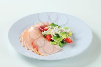 Thinly sliced turkey breast garnished with fresh salad