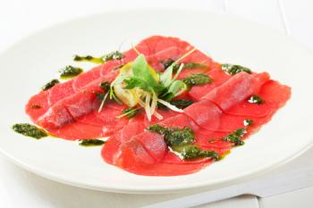 Beef Carpaccio with pesto sauce and shavings of Parmesan