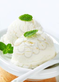Two scoops of white ice cream (lemon, yogurt or mint flavor)
