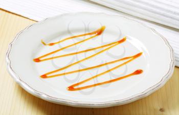 Caramel drizzle on a plate
