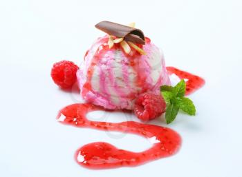 Scoop of raspberry ice cream with syrup
