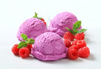 Scoops of purple ice cream and fresh raspberries