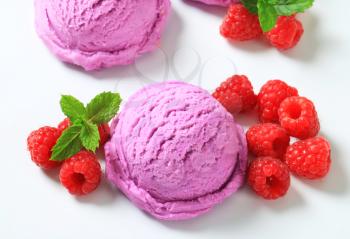 Scoops of purple ice cream and fresh raspberries