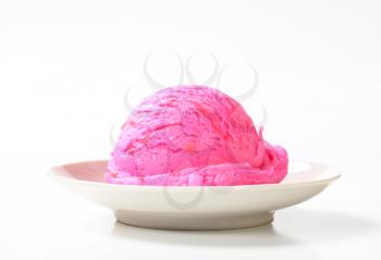 Scoop of pink ice cream on a plate