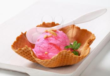 Pink fruit flavored ice cream in a waffle basket