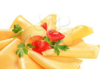 Thin slices of yellow cheese, butter curl and tomato wedges