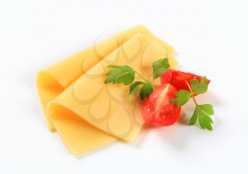 Thin slices of yellow cheese and tomato wedges
Thin slices of yellow cheese and tomato wedges