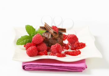 Mini chocolate cake served with fresh raspberries