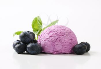 Scoop of blueberry ice cream with fresh berries