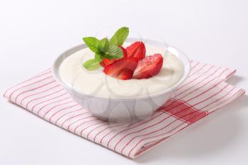 Bowl of semolina pudding with fresh strawberries