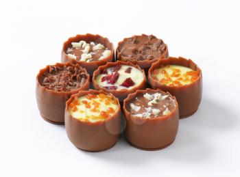 Delicate milk chocolate cups with liqueur and ganache centres