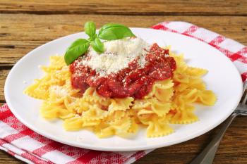 Bow-tie pasta with thick tomato sauce and parmesan
