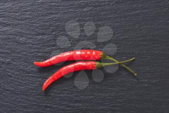 Red chili peppers on slate board