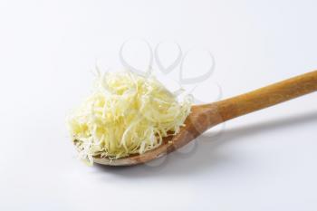 Freshly shredded horseradish on a wooden spoon