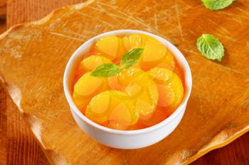 Bowl of peeled mandarin orange segments in light syrup