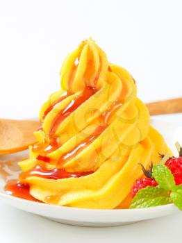 Swirl of yellow buttercream  with raspberry sauce