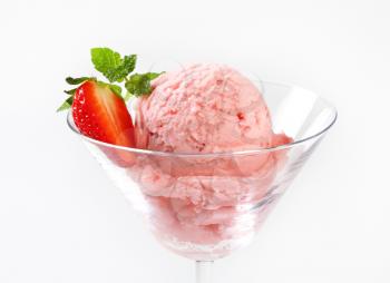 Scoop of strawberry ice cream  in stemmed glass