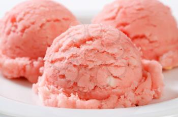 Three scoops of pink sherbet on plate