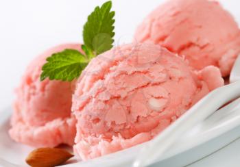 Three scoops of pink sherbet on plate