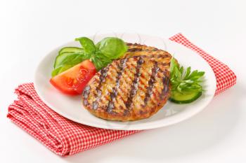 Grilled patties garnished with sliced cucumber and tomato