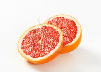 Two halves of red grapefruit