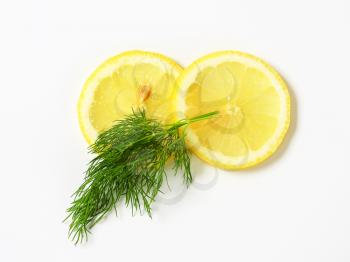 Sprigs of fresh dill weed and slices of lemon