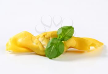 Caramelle-shaped stuffed pasta on white background