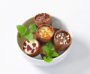 Delicate milk chocolate cups with liqueur and ganache centres