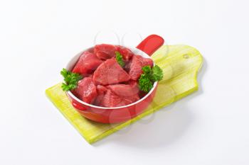 Raw diced beef in a pan