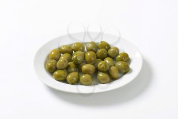 Fresh green olives on plate
