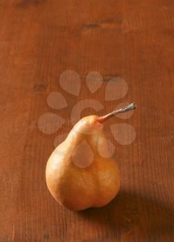 European pear with elongated slender neck and russeted skin