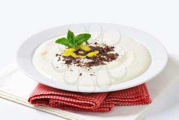 Smooth semolina porridge served with grated chocolate and lemon curd