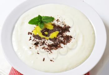 Smooth semolina porridge served with grated chocolate and lemon curd