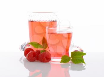 Glasses of fruit water and fresh raspberries
