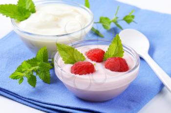 Light raspberry and white yogurt in glass bowls